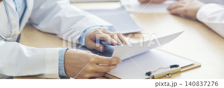 Banner hands of two women doctor medical lab discussing together healthcare teamwork. Panorama Two asian women doctors meeting write prescription medical clinic office using laptop with copy space. Banner hands of two women doctor medical lab discussing together healthcare teamwork. Panorama Two asian women doctors meeting write prescription medical clinic office using laptop with copy space. 140837276