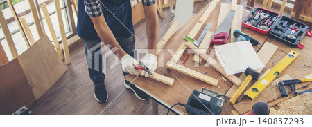 Banner DIY craftsperson asian man working wood heap carpenter objects woodwork desk. Banner Architect man hands ruler measure home improvement. Wood carpenter construction workshop with copy space 140837293