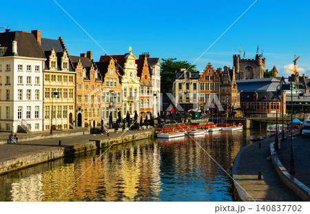 Medieval buildings in historical center of Ghent reflecting in water of river Leie Flanders Medieval buildings in historical center of Ghent reflecting in water of river Leie Flanders 140837702