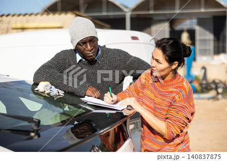 Female farmer signs the documents for the delivery of the goods to farm field 140837875