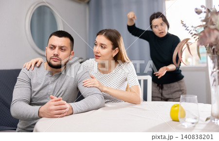 Wife comforting husband after quarrel with sister at home Wife comforting husband after quarrel with sister at home 140838201
