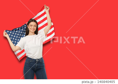 Young woman waves American flag proudly. Celebration and patriotism concept Young woman waves American flag proudly. Celebration and patriotism concept 140840405