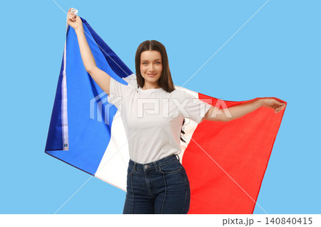 Young woman waves French flag, expressing joy and enthusiasm Young woman waves French flag, expressing joy and enthusiasm 140840415