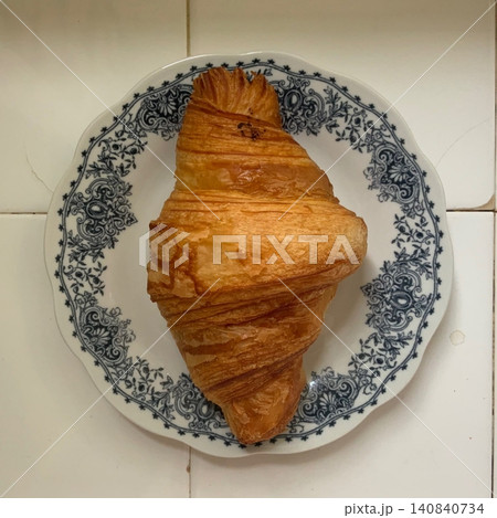 A croissant is a classic French pastry known for its buttery, flaky layers and golden crust. Often enjoyed plain or filled with chocolate, almond, or ham and cheese, it’s a perfect for breakfast A croissant is a classic French pastry known for its buttery, flaky layers and golden crust. Often enjoyed plain or filled with chocolate, almond, or ham and cheese, it’s a perfect for breakfast 140840734