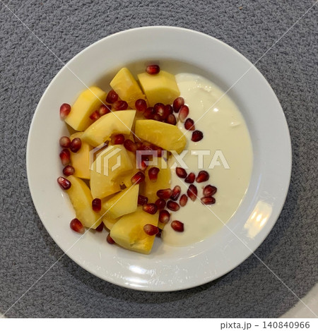 Greek yogurt served in a bowl topped with fresh colorful fruits, showcasing creamy smooth texture, vibrant natural colors, and refreshing wholesome appearance in close-up detail 140840966