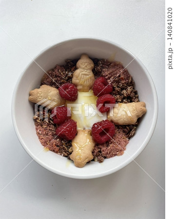 Greek yogurt served in a bowl topped with fresh colorful fruits, showcasing creamy smooth texture, vibrant natural colors, and refreshing wholesome appearance in close-up detail 140841020