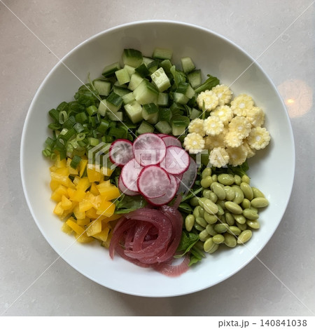 Fresh salad with a mix of crisp leafy greens, sliced vegetables, and colorful ingredients, tossed together to create a healthy, vibrant, and refreshing dish full of natural flavors 140841038