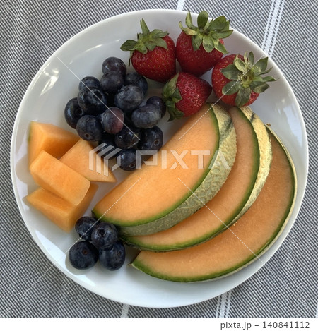 Colorful fruit platters filled with fresh, juicy slices of melon, berries, grapes, and more. Offering a perfect mix of natural sweetness, vibrant color, and refreshing flavor in every bite. 140841112