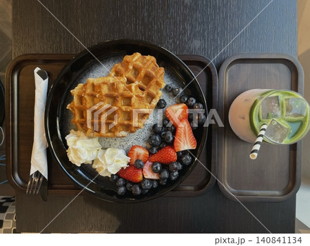 Light and creamy desserts with delicate layers, fresh fruits, and rich flavors, paired with refreshing sweet drinks. A perfect café treat for a delightful and indulgent experience. 140841134