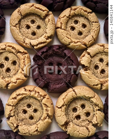 Freshly baked cookies with a golden-brown finish and chocolate chips. Perfectly crisp on the edges with a soft center, offering a delicious, comforting treat for any occasion. 140841144
