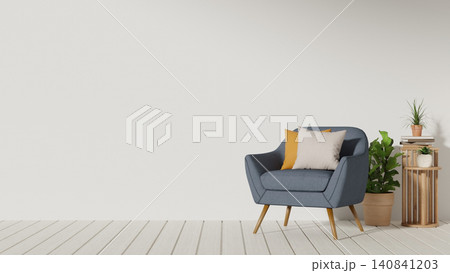 Cozy corner with blue armchair and plant with side table beside white wall in a modern living room. 140841203