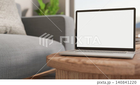 Laptop mockup on wooden coffee table in modern living room Laptop mockup on wooden coffee table in modern living room 140841220