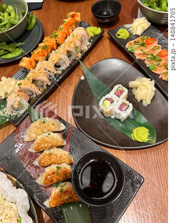 An assortment of fresh sushi, artfully arranged with a variety of toppings and vibrant colors. This traditional Japanese dish combines vinegared rice, seafood, and vegetables for an experience. An assortment of fresh sushi, artfully arranged with a variety of toppings and vibrant colors. This traditional Japanese dish combines vinegared rice, seafood, and vegetables for an experience. 140841705