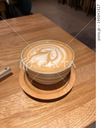 A beautifully crafted latte, featuring creamy foam art on top of rich espresso. Perfect for coffee-related projects, this image captures the warmth and inviting nature of a classic cafe experience. 140841817