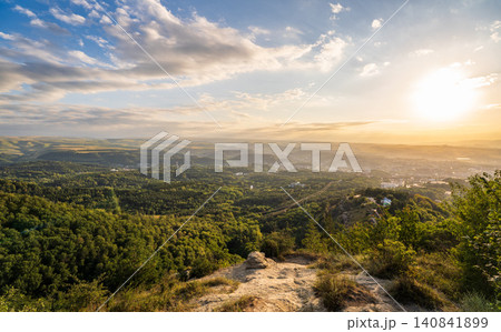 View of the mountains and Kislovodsk from the observation decks of the Kislovodsk Park. Evening sunset over the mountains of Kislovodsk. 140841899