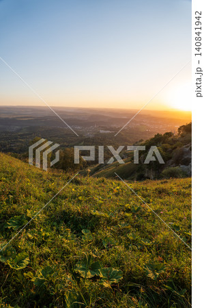 View of the mountains and Kislovodsk from the observation decks of the Kislovodsk Park. Evening sunset over the mountains of Kislovodsk. View of the mountains and Kislovodsk from the observation decks of the Kislovodsk Park. Evening sunset over the mountains of Kislovodsk. 140841942