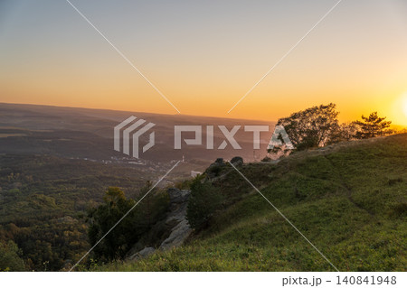 View of the mountains and Kislovodsk from the observation decks of the Kislovodsk Park. Evening sunset over the mountains of Kislovodsk. View of the mountains and Kislovodsk from the observation decks of the Kislovodsk Park. Evening sunset over the mountains of Kislovodsk. 140841948