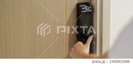 Hand using smart digital door lock while open or close the door at home or apartment. NFC Technology, Fingerprint scan, keycard, PIN number, smartphone, electrical and contactless lifestyle concepts Hand using smart digital door lock while open or close the door at home or apartment. NFC Technology, Fingerprint scan, keycard, PIN number, smartphone, electrical and contactless lifestyle concepts 140842096