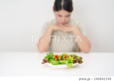 Unhappy woman disgust gesture and Bored to eat fresh organic vegetables. healthy nutrition, weight loss, clean eating, Healthy food eating, Vegan, Wellness, Green dieting and Healthy lifestyle Unhappy woman disgust gesture and Bored to eat fresh organic vegetables. healthy nutrition, weight loss, clean eating, Healthy food eating, Vegan, Wellness, Green dieting and Healthy lifestyle 140842148