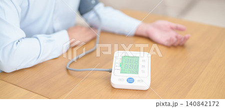 Man checking Blood pressure by Blood pressure monitor with Cuff. Systolic, SYS, Diastolic, DIA, Pulse, Hypertension, Hypotension, Heart rate, Cardiovascular Disease and May World hypertension day 140842172