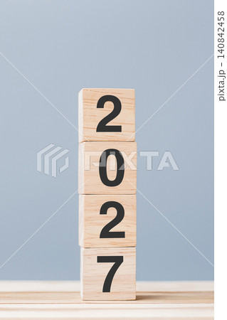 wooden cube block with 2027 text on table background. Resolution, plan, review, goal, start and New Year holiday concepts 140842458