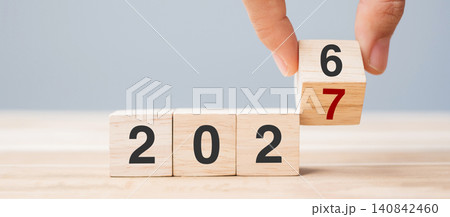 hand flip cube block 2026 to 2027 text on table. Resolution, review, strategy, end year, goal, business and New Year holiday concepts hand flip cube block 2026 to 2027 text on table. Resolution, review, strategy, end year, goal, business and New Year holiday concepts 140842460
