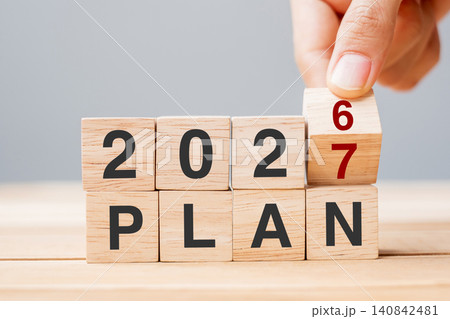 hand flipping block 2026 to 2027 PLAN text on table. Resolution, strategy, goal, motivation, reboot, business and New Year holiday concepts hand flipping block 2026 to 2027 PLAN text on table. Resolution, strategy, goal, motivation, reboot, business and New Year holiday concepts 140842481