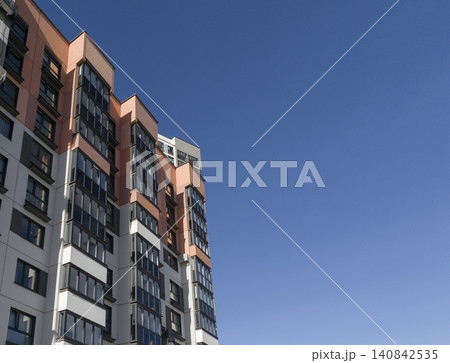 Modern apartment house corner, residential block of flats architecture against clear blue sky. Modern apartment house corner, residential block of flats architecture against clear blue sky. 140842535