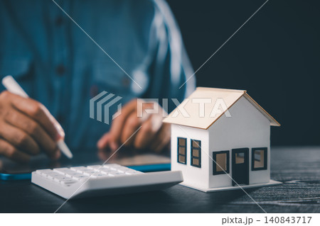 Signing real estate contract for house property mortgage finance, approved insurance home buying document, with calculator and house model for tenant investment and homeowner protection Signing real estate contract for house property mortgage finance, approved insurance home buying document, with calculator and house model for tenant investment and homeowner protection 140843717