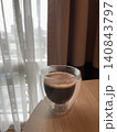 Hot Espresso in Double Wall Glass by the Window with Crema 140843797