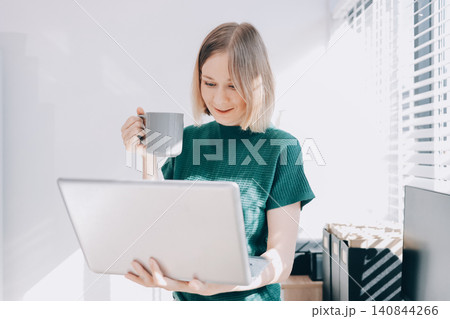 Concept of business working, Businesswoman sitting while writing and checking business analytic document report and holding tablet with computer pc, smartphone on desk in her workstation. Concept of business working, Businesswoman sitting while writing and checking business analytic document report and holding tablet with computer pc, smartphone on desk in her workstation. 140844266