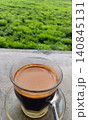 A hot cup of sanger coffee against a green nature background. 140845131