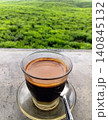 A hot cup of sanger coffee against a green nature background. 140845132