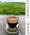 A hot cup of sanger coffee against a green nature background. 140845133