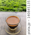 A hot cup of sanger coffee against a green nature background. 140845135