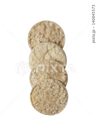 Close up photo of a vertical stack of round rice cakes against a white background. 140845573
