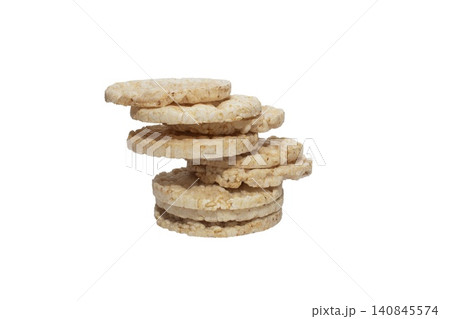 Close up photo of a vertical stack of round rice cakes against a white background. 140845574