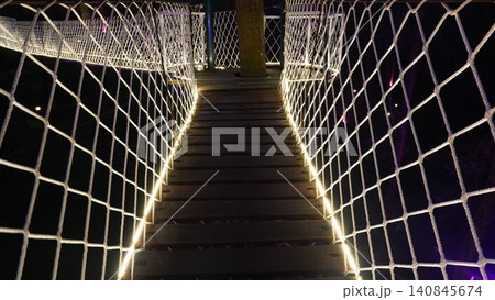 Elevated Rope Bridge at Night Adventure Concept 140845674