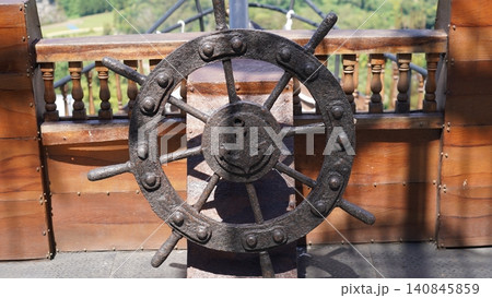Rusty Ship Wheel with Anchor Detail Rusty Ship Wheel with Anchor Detail 140845859