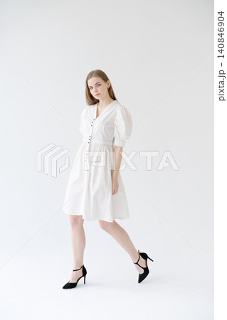 Young Woman Walking in a White Dress Spring Fashion Lookbook Young Woman Walking in a White Dress Spring Fashion Lookbook 140846904