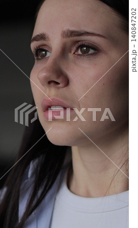 Vertical video Close up of young woman suffering from depression. Upset frustrated lonely lady thinking of grief troubled. Vertical video Close up of young woman suffering from depression. Upset frustrated lonely lady thinking of grief troubled. 140847202