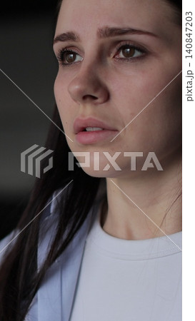 Vertical video Close up of young woman suffering from depression. Upset frustrated lonely lady thinking of grief troubled. 140847203