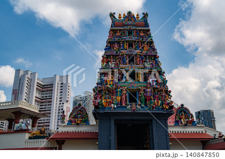 SINGAPORE - JULY 1, 2025: View of the colorful Sri Mariamman Temple's gopuram tower with Hindu deity sculptures under a bright blue sky SINGAPORE - JULY 1, 2025: View of the colorful Sri Mariamman Temple's gopuram tower with Hindu deity sculptures under a bright blue sky 140847850
