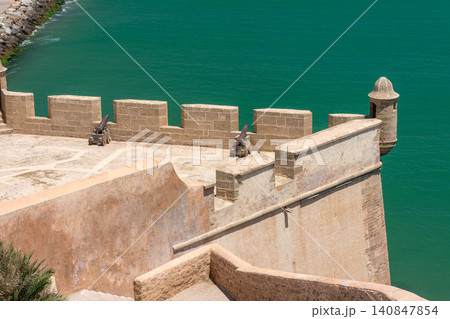 The historic cannons of the Sqala watch over the turquoise waters from the Kasbah of the Udayas in Rabat, Morocco The historic cannons of the Sqala watch over the turquoise waters from the Kasbah of the Udayas in Rabat, Morocco 140847854
