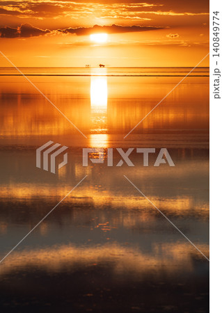 Dramatic orange sunset with reflection at Salar de Uyuni Bolivia Dramatic orange sunset with reflection at Salar de Uyuni Bolivia 140849774