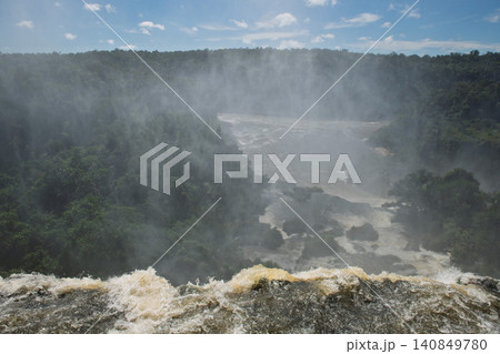 Powerful water plunges down majestic iguazu falls creating magnificent heavy mist Powerful water plunges down majestic iguazu falls creating magnificent heavy mist 140849780