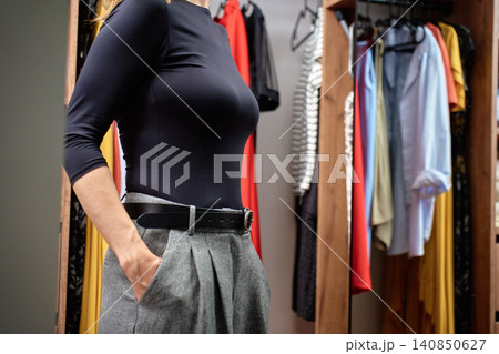 Woman checking outfit before work In wardrobe Woman checking outfit before work In wardrobe 140850627