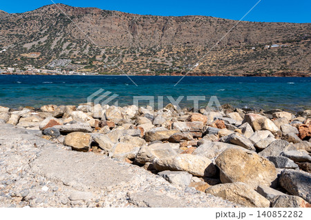 Rocky Coast of Spinalonga Island Facing Crete Mountain Landscape Rocky Coast of Spinalonga Island Facing Crete Mountain Landscape 140852282