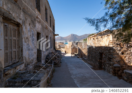 Abandoned stone street with ruined buildings on historic Spinalonga island Greece Abandoned stone street with ruined buildings on historic Spinalonga island Greece 140852291