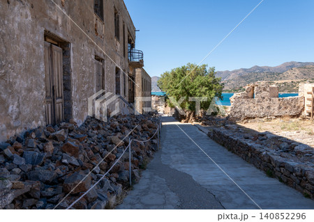 Abandoned stone street with ruined buildings on historic Spinalonga island Greece Abandoned stone street with ruined buildings on historic Spinalonga island Greece 140852296